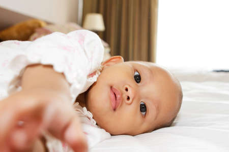 cute asian ethnic baby girl lay on bed