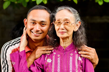 family portrait of asian ethnic senior mother with young adult son