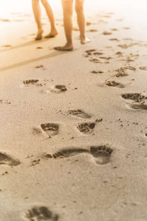 people foot prints on the beach sandの写真素材