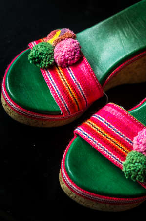 A Pair of Colorful Woman High Heel Sandals Isolated on Black
