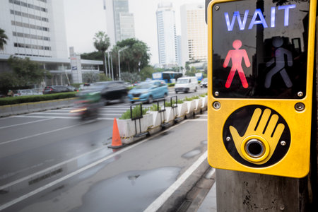 Wait signal sign located at pedestrian crosswalk area on a busy city street