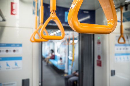 Closeup of yellow hand grip inside a subway train