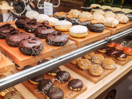 Donuts of various flavors and toppings displayed at a local food stall