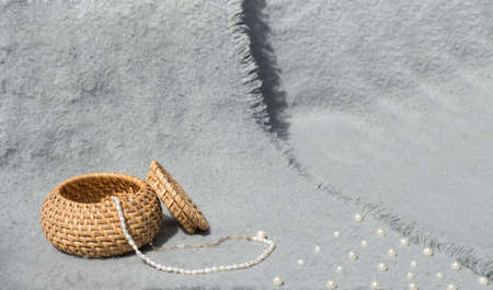 A box of reeds with pearls on a gray background. Minimalist conceptの写真素材