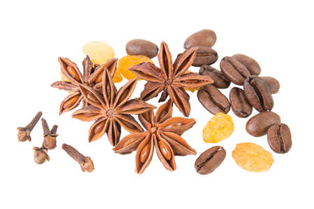 Anise star with cloves, coffee beans and raisins on white background top viewの写真素材