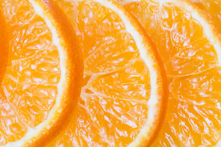 Citrus fruit. Mandarine fresh slices. Orange background