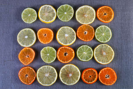 Slices of different varieties of citrus fruits on the textileの写真素材