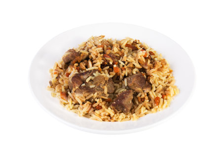 Aromatic pilaf on a platter with meat and spices on white backgroundの写真素材