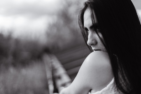 portrait of a young brunette girl who looks strong gaze into the distanceの写真素材