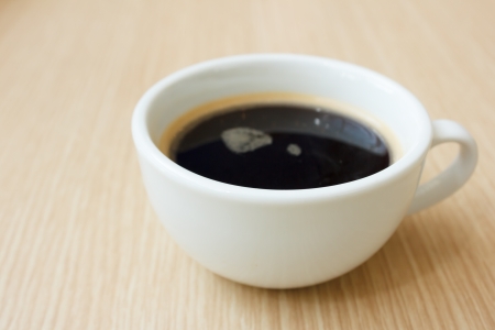 close up cup of coffee  on wooden tableの写真素材