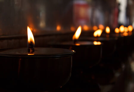 Burning candles in Thai templeの写真素材