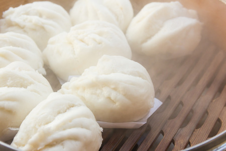 Chinese steamed buns stuffed red pork in bamboo basketの写真素材