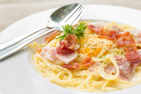 spaghetti carbonara with bacon and raw egg yolkの写真素材