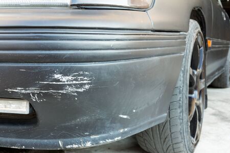 Scratch on a black car bumperの写真素材