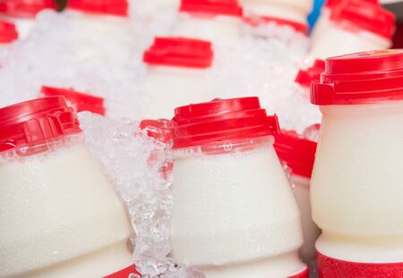 close up of milk bottles plastic chilled in iceの写真素材