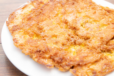 close up of thai omelette on a white plateの写真素材