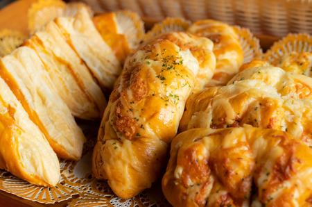 close up of cheese breads on wooden tray
