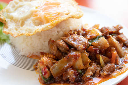 stir fried pork with chili paste and rice with fried egg on top,Thai foodの写真素材