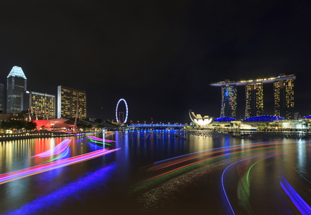 Singapore, Singapore - December 12, 2015 : Lighting of tourist boat and night view of Marina Bay, a famous tourist attractions in Singapore.のeditorial素材