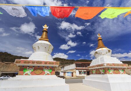 Prayer flags and stupas at the gate of Deqing city, Yunnan, Chinaの写真素材