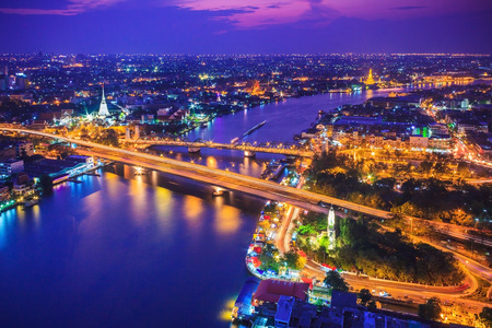 Bangkok city skyline and Chao Phraya River, located near Phra Phuttha Yodfa Bridge under twilight evening sky.の写真素材