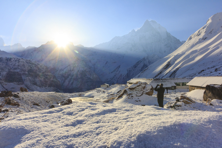 Close-up snow and sunrise behind Himalaya Machapuchare mountain in background, morning view from Annapurna base camp, famous trekking destination in Nepal.の写真素材