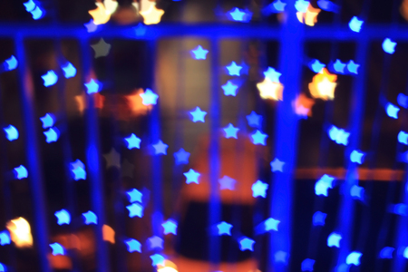 Blue star shape light bokeh background, from nightlife city and festive Christmas night decoration.の写真素材