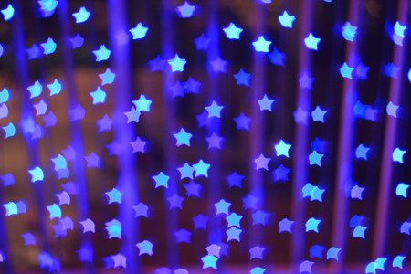 Blue star shape light bokeh background, from nightlife city and festive Christmas night decoration.の写真素材