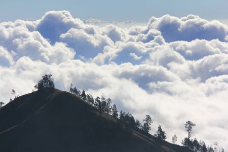 Clouds above mountain high at Mountain Rinjani, active volcano at Lombok island of Indonesia.の写真素材