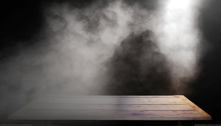 Empty wooden table with smoke on black background. Ready for product display montageの写真素材