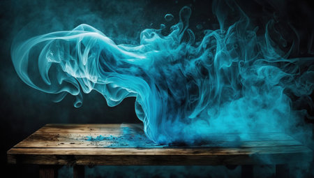 Blue cloud of smoke on a wooden table. Blue smoke on a black background.の写真素材