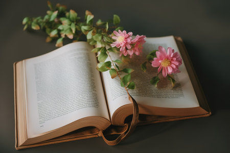 Open book with pink flower on the background of green branches and leaves. generative aiの素材