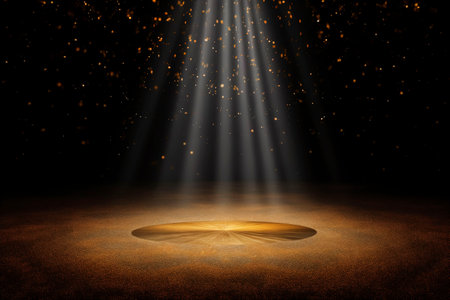 Spotlight on stage with golden bokeh background.の素材