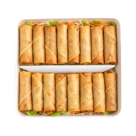 Fried spring rolls with vegetables in a container on a white backgroundの素材