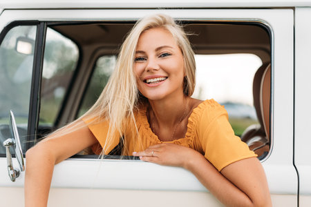 Happy female looking out of a window of van