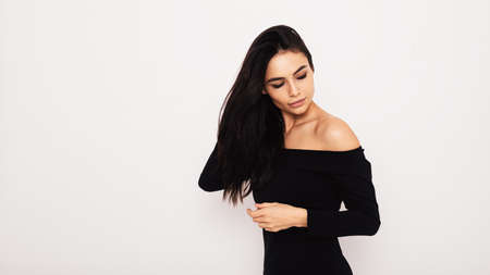 Attractive woman in black dress with open shouldersの写真素材