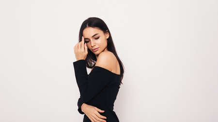 Attractive woman in black dress with open shouldersの写真素材