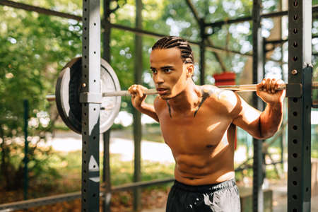 Young kickboxer standing at a wall after training looking at the camera