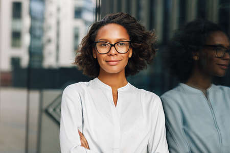 Woman driving a car. Side view of a female driver wearing glasses and looking away.