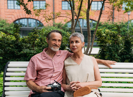 Aged couple sitting on a bench in the parkの写真素材