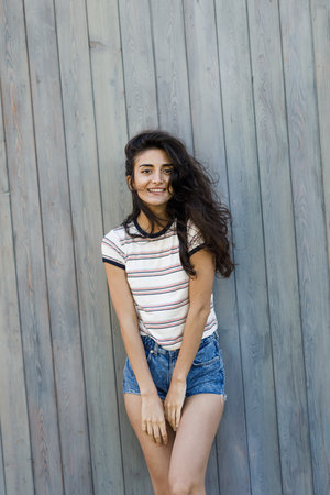 Outdoor shot of a young beautiful woman with black hairの写真素材