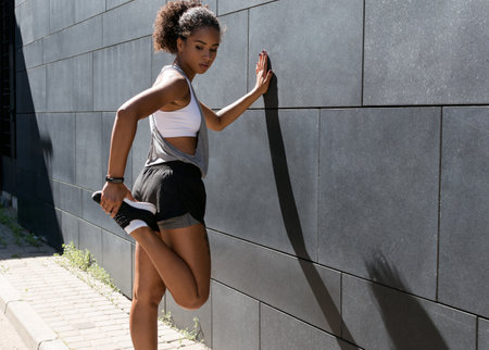 Woman in sports clothes stretching before a workout