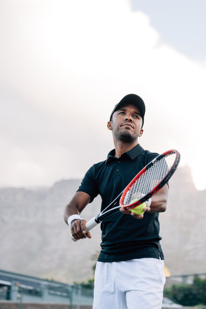 Tennis player preparing to serve the ball in a matchの写真素材