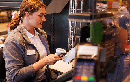 Female cashier scanning a barcode in a supermarketの写真素材