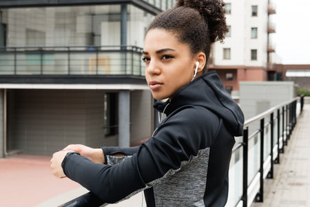 Portrait of a young woman wearing sports clothes outdoors