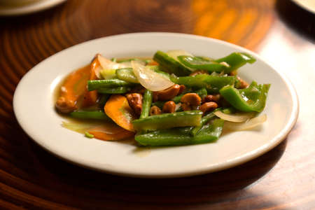 fried vegetables with cashews nuts on the tableの写真素材