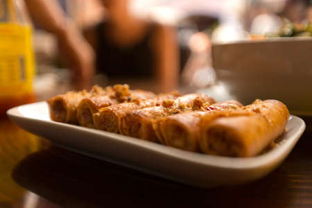 Fried spring rolls with a peanut sauceの写真素材