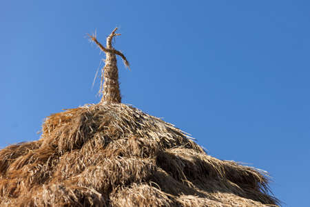 strawy roof of the country farm house with sky backgroundの写真素材