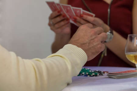 Girl gives a deck of cards to the manの写真素材