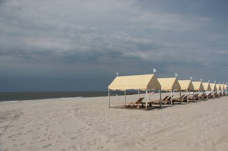 Beach cabanas and deckchairs for hire at the seasideの写真素材